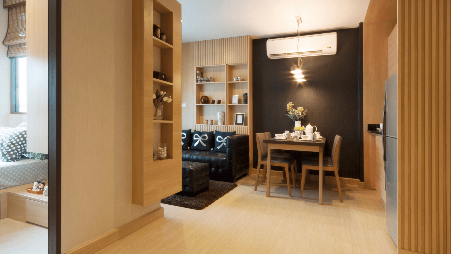 Cozy living room in Ethiopian condo with couch, table, and refrigerator.