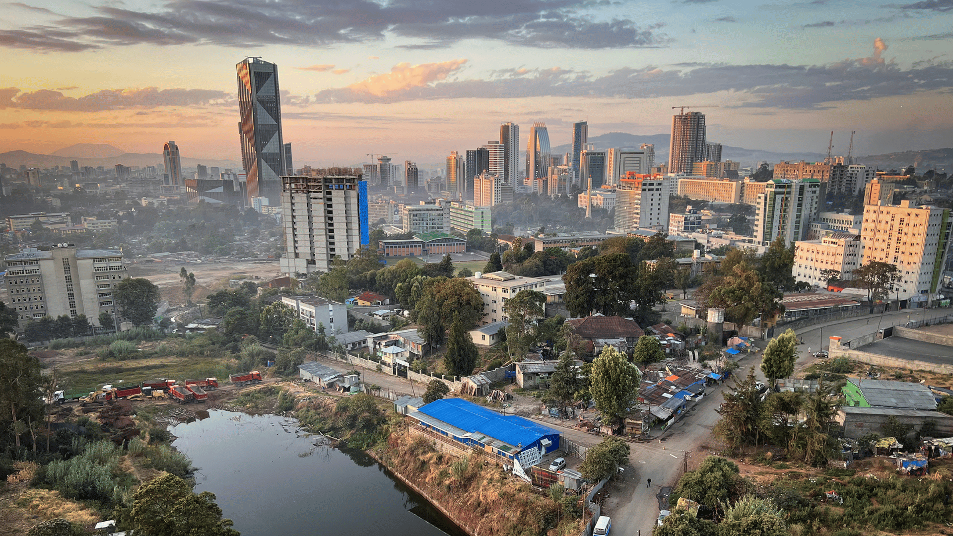 City skyline with river and buildings in background, showcasing Addis Ababa Real Estate Market.